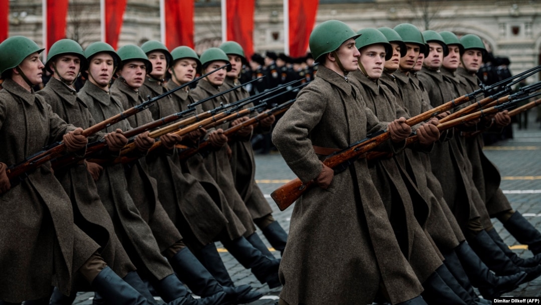 Russian servicemen dressed in historical uniforms march during a military parade on Red Square in Moscow on November 7, 2019.