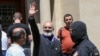 Armenia - Archbishop Bagrat Galstanian waves to supporters as he is arrested in Yerevan, June 25, 2025.