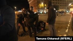 Protesters are detained early on November 29 in central Tbilisi.