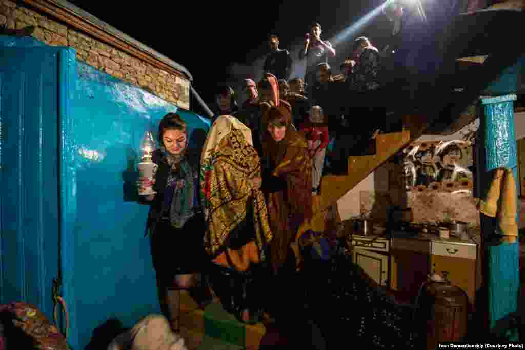 Villagers gather for the nighttime wedding procession.