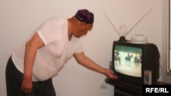 Kazakhstan - the resident of new district Sayaly is watching TV. 11Jul2009