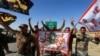 Shi'ite Popular Mobilization Forces (PMF) celebrate on the outskirts of Kirkuk, October 17, 2017