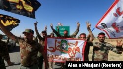 Shi'ite Popular Mobilization Forces (PMF) celebrate on the outskirts of Kirkuk, October 17, 2017