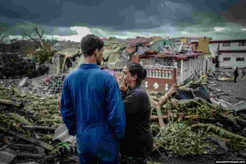 A resident of the tornado-hit Regla neighborhood in Havana cries in front of her destroyed house. A rare and powerful tornado that struck Havana killed three people and left 172 injured. (AFP/Adalberto Roque)