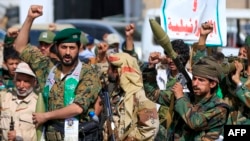 Fighters loyal to Yemen's Houthi rebels shout slogans during a rally to recruit more fighters in Sanaa on September 10.
