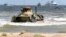 A Russian BTR-82A armored personnel carrier drives onto the shore during military exercises on the Caspian Sea coast in Daghestan in September 2019.