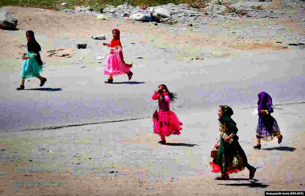 Afghan girls play as they celebrate the Muslim festival of Eid al-Adha in Kabul. (epa-EFE/Hedayatullah Amid)