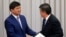 New Prime Minister Mukhammetkalyi Abylgaziev (left) is congratulated by President Sooronbai Jeenbekov in parliament in Bishkek on April 25.