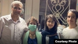 Nasrin Sotoudeh (masked) poses with her husband and children after her release from prison on July 21.