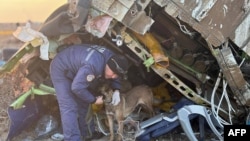 Emergency workers at the crash site of the Azerbaijan Airlines passenger jet near the western Kazakh city of Aktau.