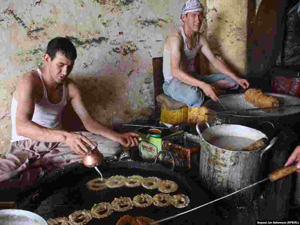 Afghan bakers make the traditional sweet "jalabi" during the Islamic holy month of Ramadan in Kabul.