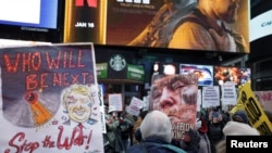 People protest against the US strikes on Venezuela during an anti-war rally in Times Square in New York.