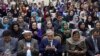 Afghan Chief Executive, Abdullah Abdullah (C) prays during an event marking International Women's Day, in Kabul on March 8