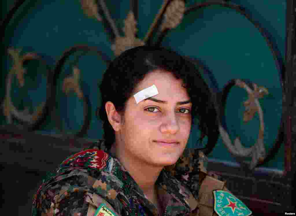 Syria -- A female Kurdish fighter from the People's Protection Units (YPG) rests in Raqqa, June 15, 2017