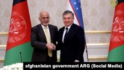 Afghan President Ashraf Ghani (left) shakes hands with his Uzbek counterpart, Shavkat Mirziyoev, in Tashkent on December 5.