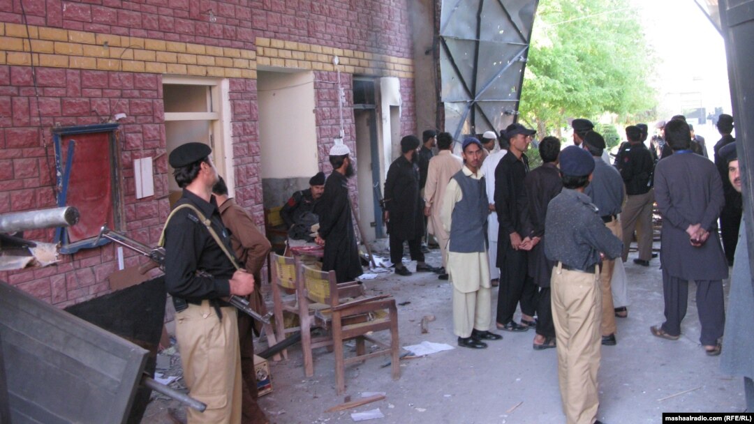 Pakistani police and security forces gather outside the prison in Bannu after the militant attack.