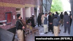 Pakistani police and security forces gather outside the prison in Bannu after the militant attack.