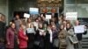 Nasrin Sotoudeh (center, holding flower) demonstrates in front of Iran's Bar Association last month along with a number of supporters.