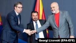 Serbian President Aleksandar Vucic (left), North Macedonia's prime minister, Zoran Zaev (center), and Albanian Prime Minister Edi Rama pose for photographers after signing documents during the Skopje Economic Forum on Regional Cooperation on July 29. 