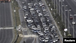 Cars line up at a checkpoint set up by Gulf Cooperation Council forces deployed in Bahrain. 