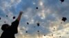 ROMANIA -- Students of the the Polytechnic Institute wearing face masks throw their hats into the air during the graduation ceremony for the 2020 university year in Bucharest, July 12, 2020