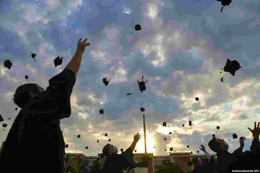 Students from a Bucharest college throw their hats into the air during a graduation ceremony for the university year of 2020. (AP/Andreea Alexandru)