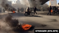 Iranian protesters block a highway amid angry protests against a fuel price increase, in Isfahan on November 16. 