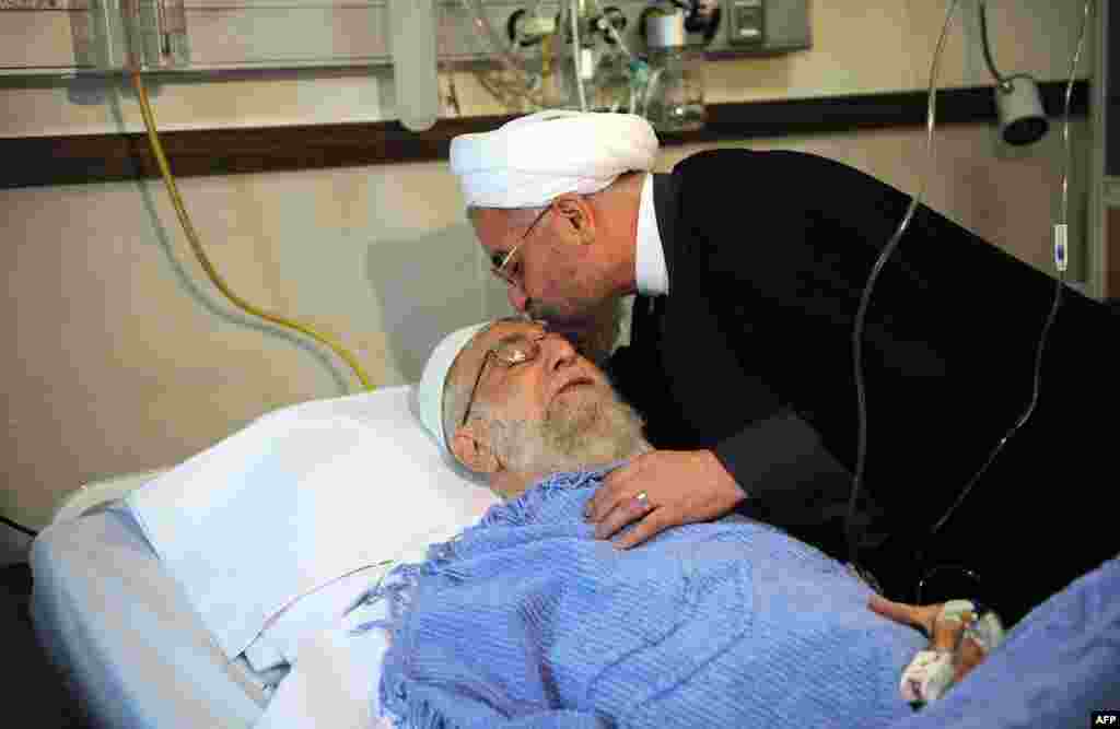 Iranian President Hassan Rohani visits Supreme Leader Ayatollah Ali Khamenei after his prostate operation at a hospital in Tehran. (AFP via Khamenei&#39;s website)