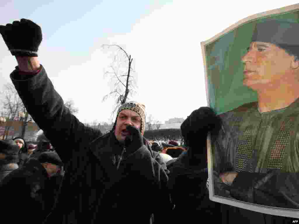 Russian Communist Party supporters shout as they hold a picture of Libyan leader Muammar Qaddafi during a rally devoted to the Defenders of the Fatherland Day holiday in Moscow on February 23. Photo by Aleksei Sazonov for AFP