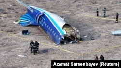 A drone view shows emergency specialists working at the crash site of an Azerbaijan Airlines passenger plane near the city of Aktau, Kazakhstan, on December 25.