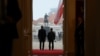 Polish President Karol Nawrocki (left) and Ukrainian President Volodymyr Zelenskyy seen from behind during a welcoming ceremony at the Presidential Palace in Warsaw in December 2025. 