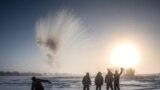 RUSSIA - A villager throws hot water into the air while harvesting ice from a local lake near the settlement of Oy, some 70 km south of Yakutsk, with the air temperature at about minus 41 degrees Celsius, on November 27, 2018