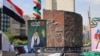 A picture of slain supreme leader Ayatollah Ali Khamenei and a sculpture of late supreme leader Ayatollah Ruhollah Khomeini stand on a Tehran street.