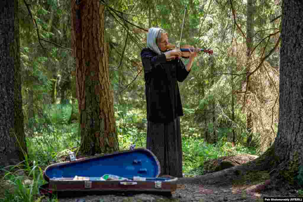 Yelena plays violin for tourists and teaches music to the local monks. She moved to the island 31 years ago, but is also faced with eviction as the church reclaims its property.