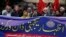 Pakistani journalists and rights activists hold a banner reading "Solidarity With Dawn Workers" during a demonstration in Islamabad on December 5.