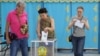 Voters cast their balots at a polling station during a snap parliamentary election in Almaty, Kazakhstan, on August 23.