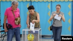 Voters cast their balots at a polling station during a snap parliamentary election in Almaty, Kazakhstan, on August 23.