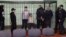 (Left to right:) Dzmitry Papou, Artsyom Sakau, Uladzimer Tsyhanovich, Ihar Losik, Syarhey Tsikhanouski, and Mikalay Statkevich in the defendants' cage during the court hearing where they were sentenced in Homel on December 14.