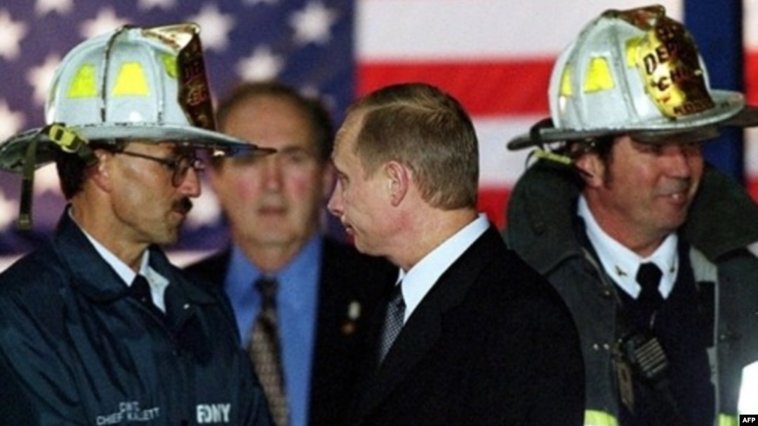 Russian President Vladimir Putin (center) with U.S. firefighters on November 15, 2001, as he visits the site of the September 11 terrorist attack that destroyed the twin towers of the World Trade Center in New York. 