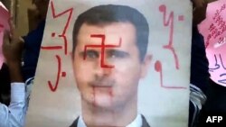 Оппозиционеры выразили свое отношение к Башару Асаду, "разукрасив" его портрет