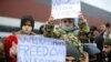 Migrants protest outside a transport and logistics center on the Belarusian side of the border with Poland on November 25.