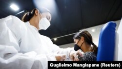 Egy olasz nőt Moderna-vakcinával oltanak be Rómában 2021. augusztus 5-én