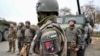 Ukrainian soldiers of the 155th Separate Mechanized Brigade stand next to military vehicles during a training exercise in France. (file photo)