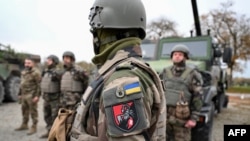 Ukrainian soldiers of the 155th Separate Mechanized Brigade stand next to military vehicles during a training exercise in France. (file photo)