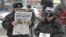 Russian police officers read newspapers on the street in central Moscow. (file photo)