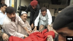 An injured man is taken into a hospital in Peshawar after a suicide bomber struck a military convoy. At least 41 people were killed in the attack.