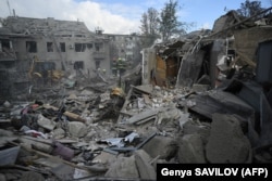 Ukrainian rescuers clear debris at the site of a Russian missile strike in Dnipro, eastern Ukraine, in October.