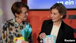 Germany’s first lady, Elke Buedenbender (left) and Olena Zelenska, the wife of Ukrainian President Volodymyr Zelenskiy, share a moment at the Frankfurt Book Fair on October 22. 