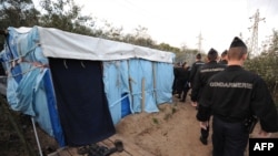 French police arrive to dismantle the makeshift tents of would-be immigrants in a wooded area known as "The Jungle" in Calais.