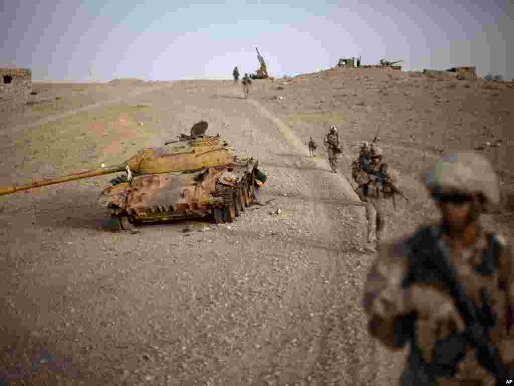 SSRİ-nin Əfqanıstana hücumundan qalan bu tankın qalıqları yanında indi ABŞ əsgərlərinin postu yerləşib. Şəkil iyulun 26-da Helmand əyalətində çəkilib. Foto: AP - David Goldman